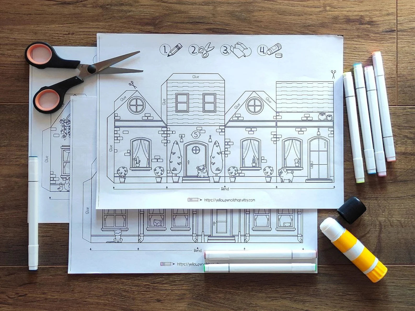 Blueprints of a house with drawing tools on a wooden surface