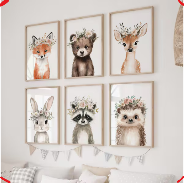 Set of six framed animal prints with floral crowns on a wall.