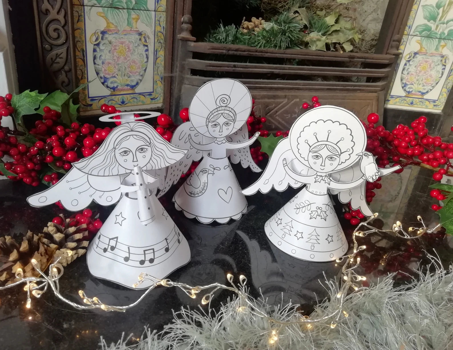 White angel figurines on a reflective surface with decorative background